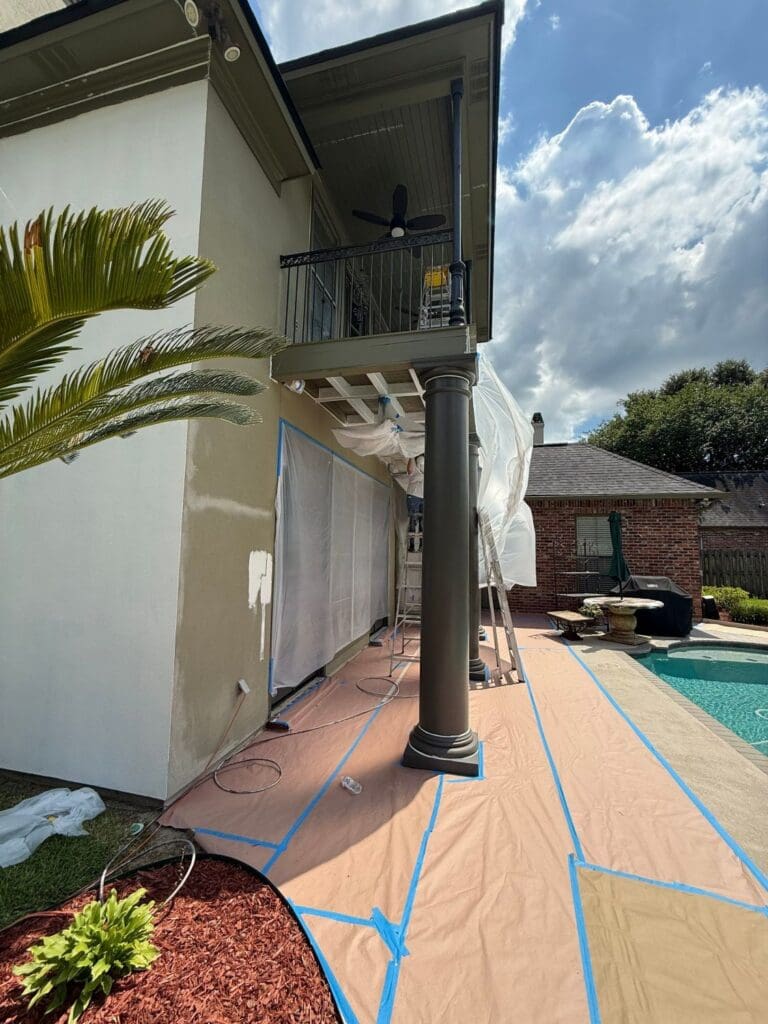 Side balcony masked for spraying during St. George, LA exterior painting project
