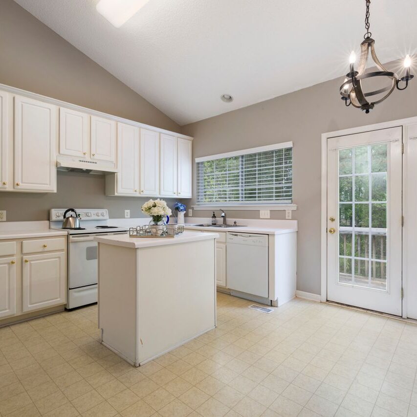 Kitchen cabinet painters in Baton Rouge LA painted the cabinetry, range hood, and island in this kitchen
